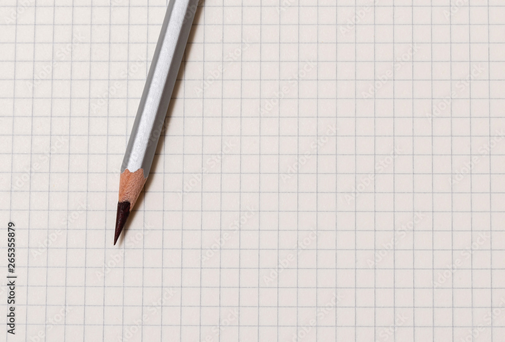 white checked notebook and gray pencil closeup white checked notebook and gray pencil closeup