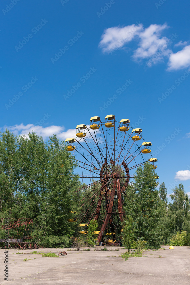 Fototapeta premium Abandoned carousel and abandoned ferris at an amusement park in the center of the city of Pripyat, the Chernobyl disaster, the exclusion zone, a ghost town