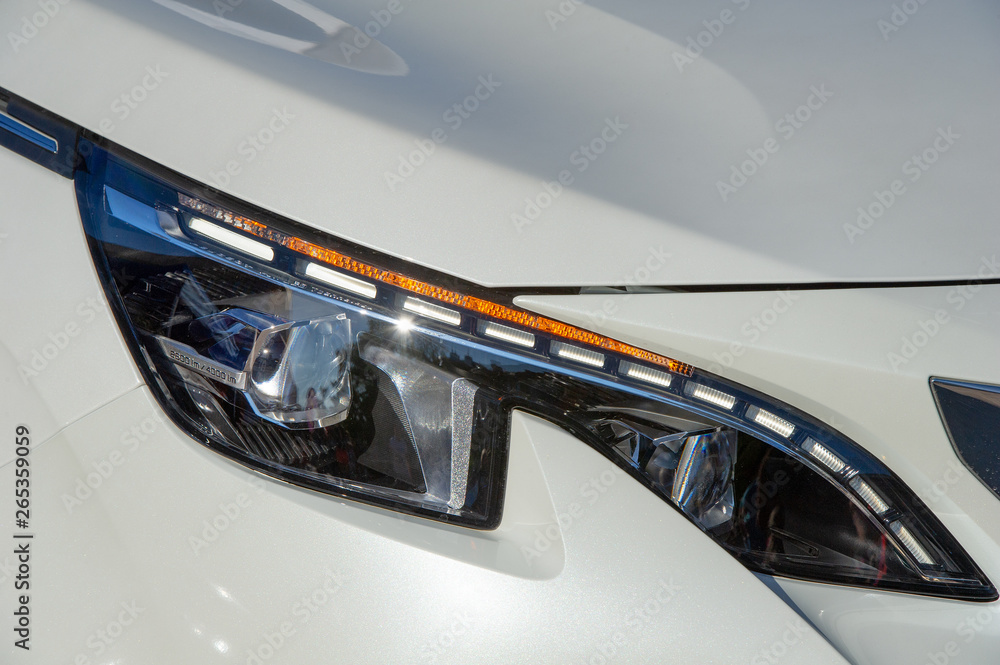 Closeup of car headlight. Modern LED headlights provide a wide range of vision and can save drivers money over the lifetime of a car, and are increasingly becoming a standard feature in new car models