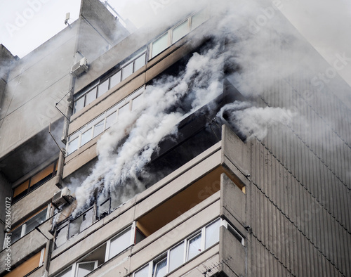 Fire and smoke blaze from apartment in a high building