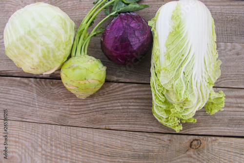 Set of different type of cabbage on rustic wooden table