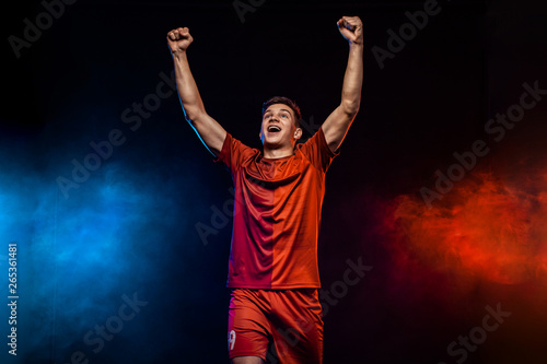 Happy teenager - soccer player. Boy in football sportswear after goal celebrating. Sport concept.