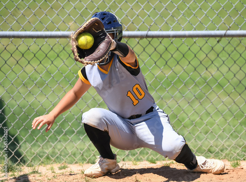 Photography Young high school softball players in action, making amazing plays, during a gam