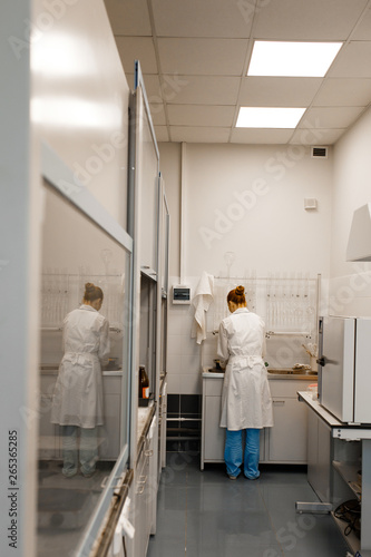 Young student in a modern laboratory. standing by the sink. The photo illustrates science and education.