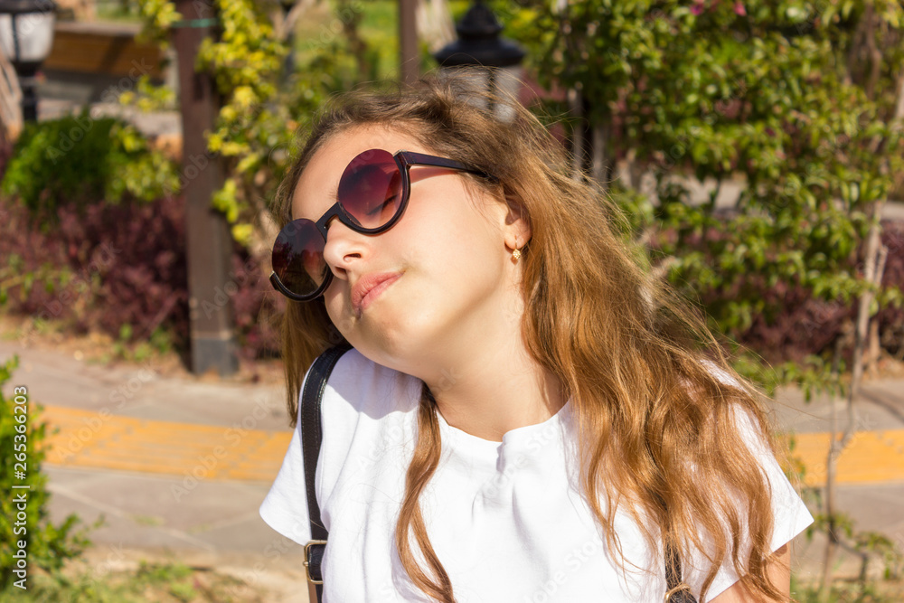 Pretty young girl with sunslasses chilling out in park Pretty young girl with sunslasses chilling out in park