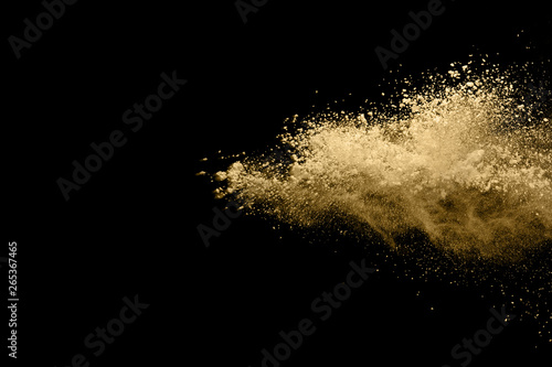 Fototapeta Naklejka Na Ścianę i Meble -  Golden powder explosion on black background. Freeze motion.