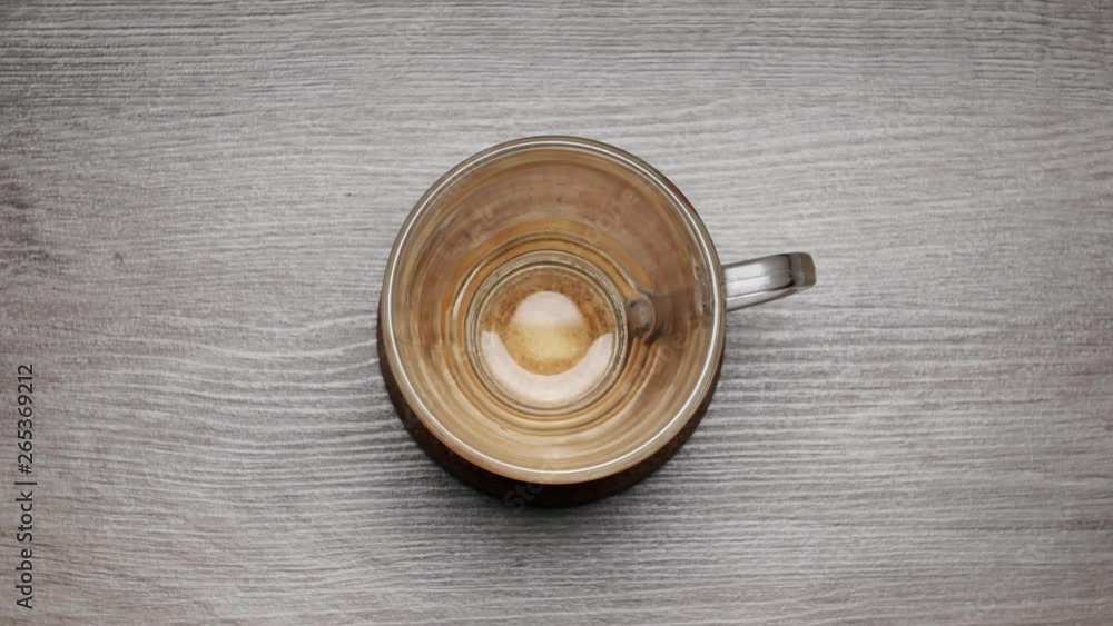 Drinking of black tea from a teacup on a white background - Stop motion. TIME LAPSE cup of tea. Drinking of black tea from a teacup on a white background - Stop motion. TIME LAPSE cup of tea.
