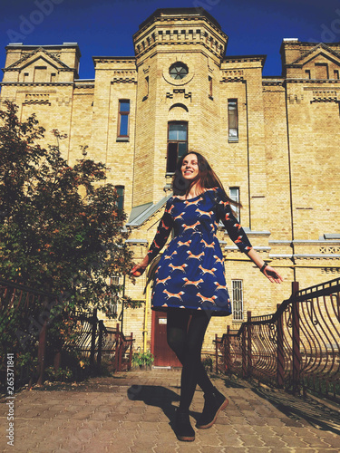young girl dancing in the street on sunset lights, having fun
