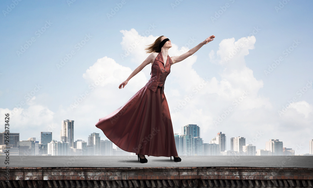 Blind woman in long red dress at top of building. Mixed media Blind woman in long red dress at top of building. Mixed media