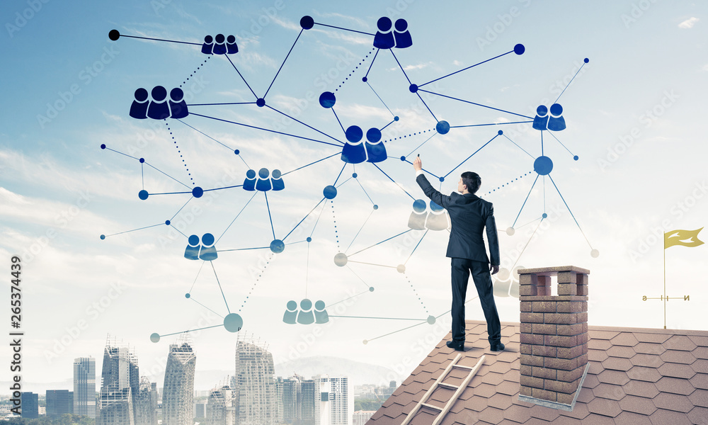 Businessman on house roof presenting networking and connection c