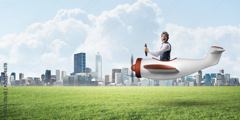 Young aviator driving small propeller plane Young aviator driving small propeller plane