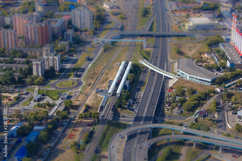 The view from the observation deck of Moscow. Tilt-shift effect. Moscow Central Ring station. Top view of Moscow city. Summer in the city. Sunny day. City roads.