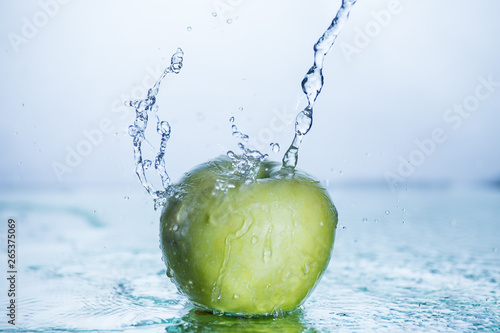 Green apple with freezed water splash