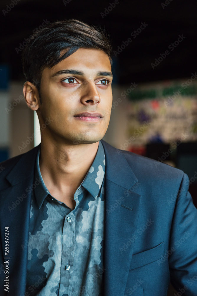 Portrait of a young millennial businessman in the workplace; Sherwood Park, Alberta, Canada Portrait of a young millennial businessman in the workplace; Sherwood Park, Alberta, Canada