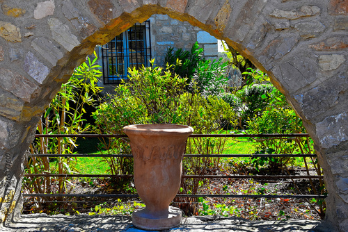 old vase in the garden of Provence in frame of old stones