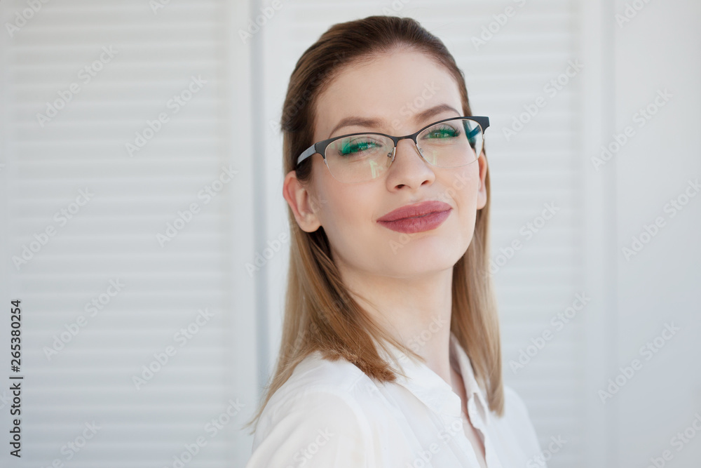 Stylish glasses in a thin frame, vision correction. Portrait of a young woman Stylish glasses in a thin frame, vision correction. Portrait of a young woman