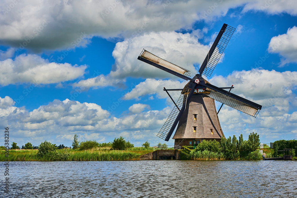 Netherlands rural lanscape with windmills at famous tourist site Kinderdijk in Holland. Old Dutch village Kinderdijk, UNESCO world heritage site. Netherlands rural lanscape with windmills at famous tourist site Kinderdijk in Holland. Old Dutch village Kinderdijk, UNESCO world heritage site.
