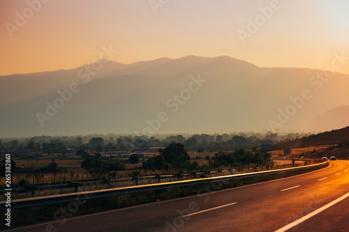 Beautiful sunset on open highway passing through the countryside