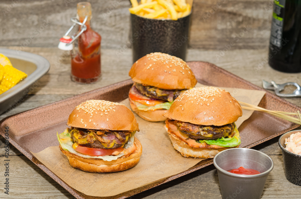 Homemade delicious three mini burgers served with salad, sauce and french fries. Homemade mini burger sliders. Homemade delicious three mini burgers served with salad, sauce and french fries. Homemade mini burger sliders.