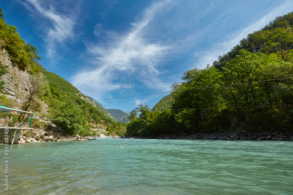 Landscape with mountains, forest and a river in front Landscape with mountains, forest and a river in front