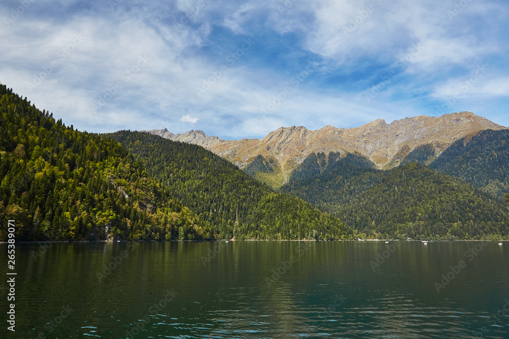 Landscape with mountains, forest and a lake in front Landscape with mountains, forest and a lake in front