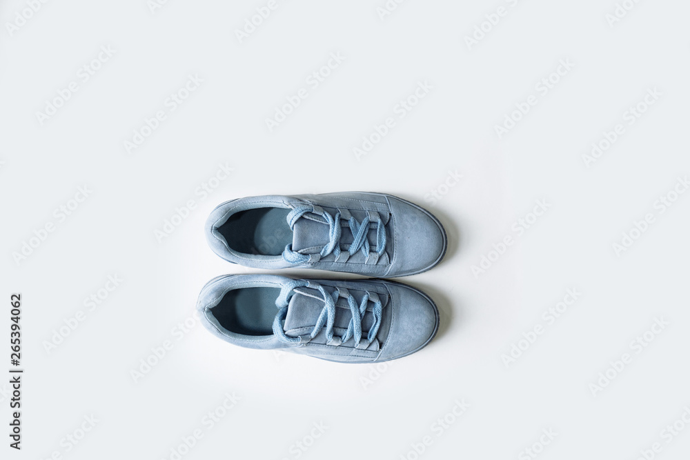 pair of blue suede shoes with thick laces on a white background pair of blue suede shoes with thick laces on a white background