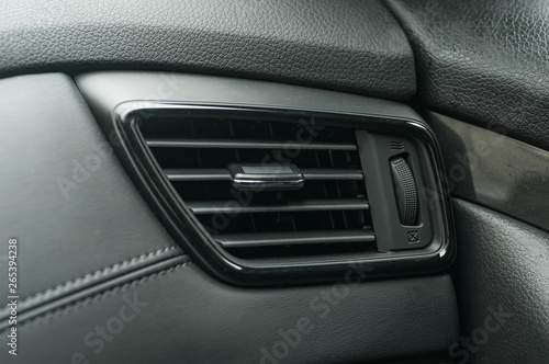 Air conditioner system in modern car, closeup. air duct grille of modern car. © eteri