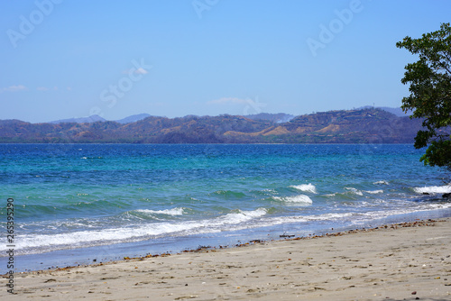 View of the black sand volcanic Playa Sombrero Obscuro beach in Peninsula Papagayo in Guanacaste, Costa Rica