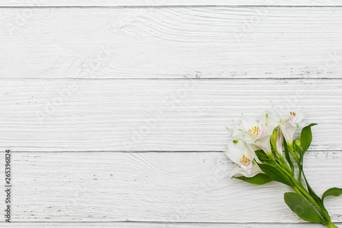 Flat lay with White lilies on old white wooden background.