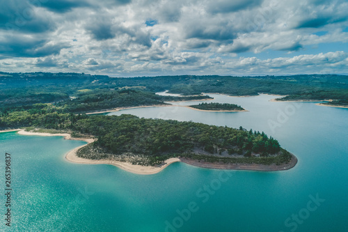 Aerial view of Cardinia Reservoir Lake scenic forested coastline on cloudy day in Victoria, Australia photo