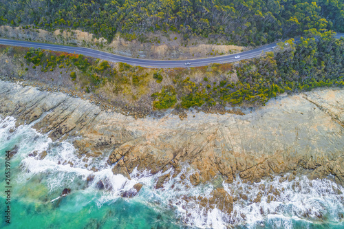 Looking down at cars driving on Great Ocean Road near the coastline