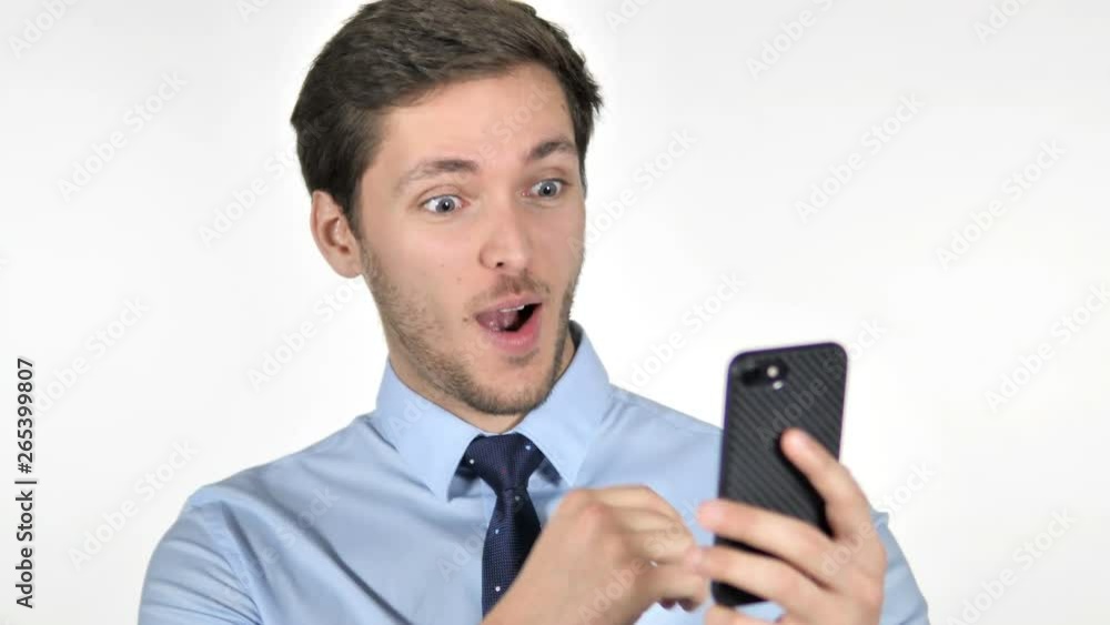 Wow, Astonished Young Businessman Using Smartphone on White Background Wow, Astonished Young Businessman Using Smartphone on White Background