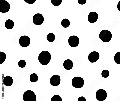 Seamless repat pattern with black irregular hand-drawn polka dots on a white background