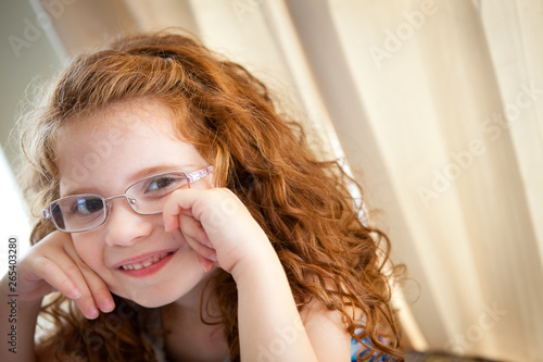 Happy Little Red Haired Girl Wearing Glasses - Portrait
