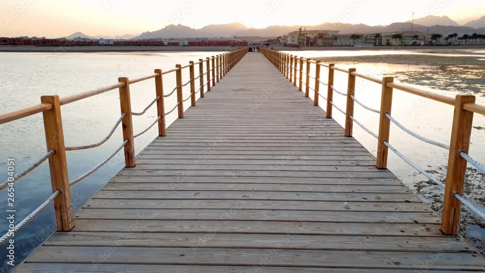 4k video of walking on the endless wooden pier in the ocean. Big waves rolling over the coast 4k video of walking on the endless wooden pier in the ocean. Big waves rolling over the coast
