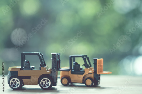 Miniature yellow forklift model on wooden table