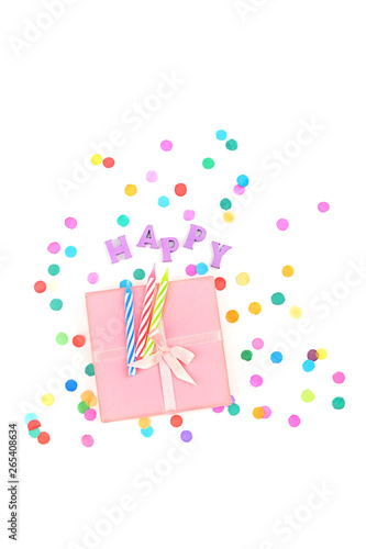 gift box, birthday candles, word of letters "happy" and colored confetti isolated on white background. happy, congratulations, minimalism creative concept. top view, copy space
