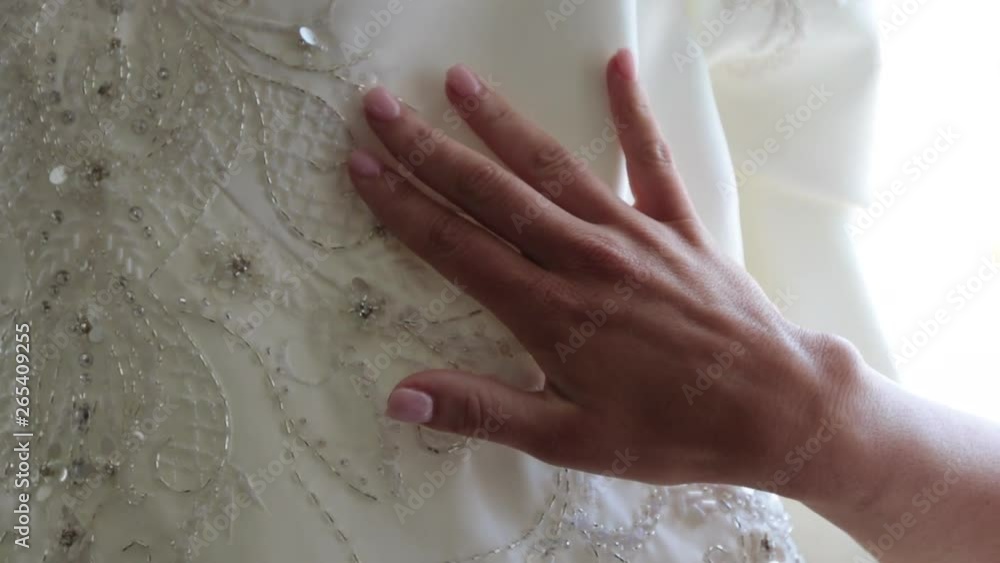 Woman’s hand slowly moving down wedding dress Woman’s hand slowly moving down wedding dress