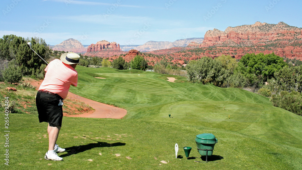 Golfer driving the ball on a Sedona Arizona golf course Golfer driving the ball on a Sedona Arizona golf course