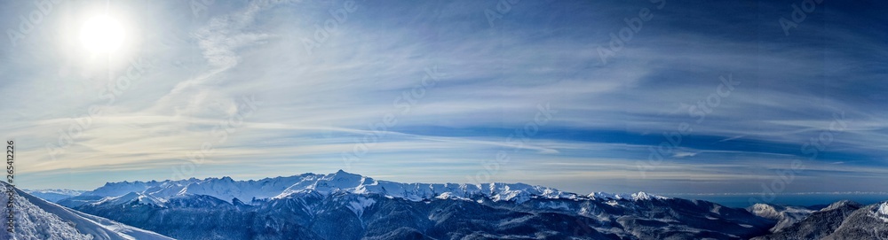 Panoramic view of the Caucasus mountains covered by snow in the ski resort of Krasnaya Polyana, Russia.