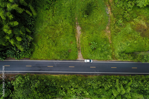 Aerial view green mountain forest with rural road