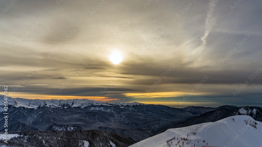 Sunset over the Caucasus mountains covered by snow in the ski resort of Krasnaya Polyana, Russia.