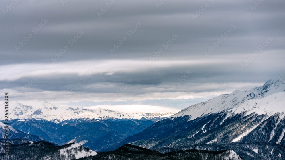 Awesome view of the Caucasus mountains covered by snow in the ski resort of Krasnaya Polyana, Russia.