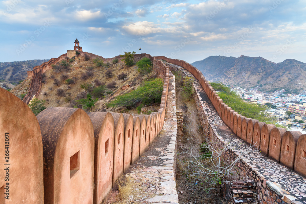 Ancient long wall with towers around Amber Fort at evening. Rajasthan. India