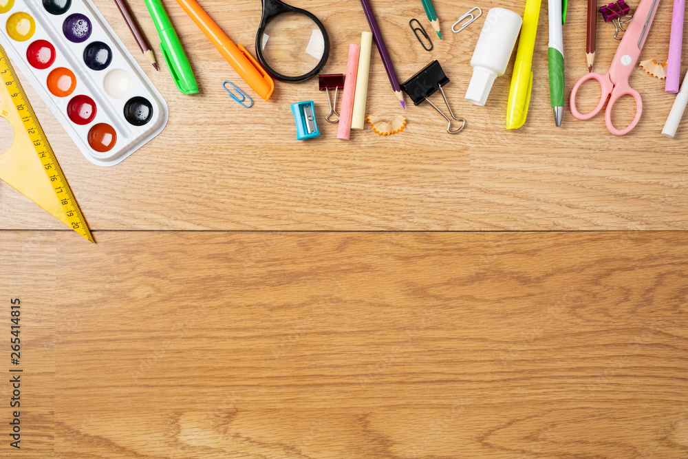 Top down view of school supplies and lunch on a light background