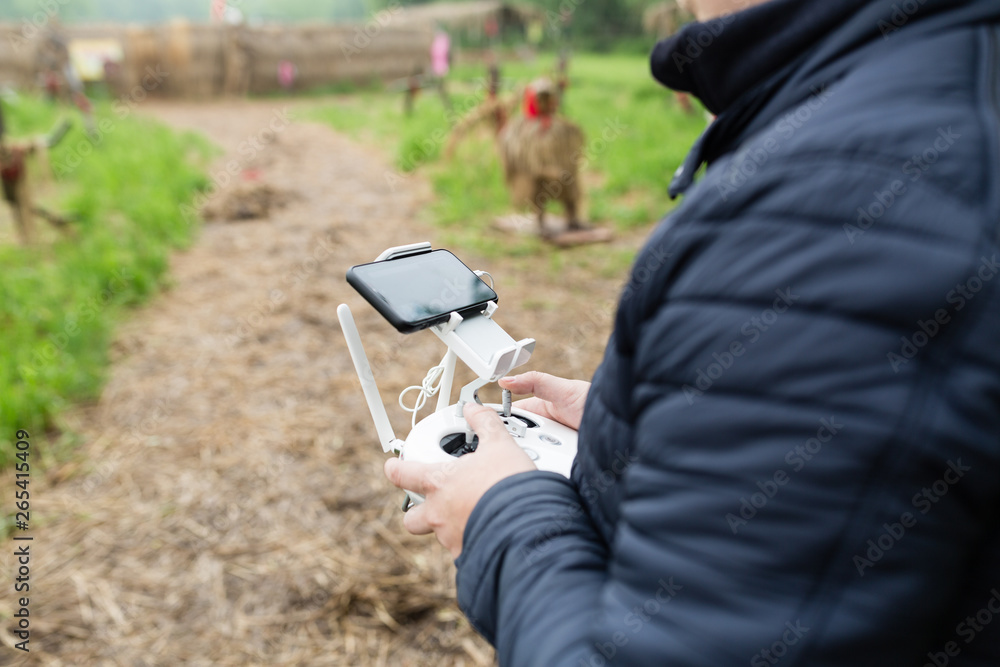Men's hands holding remote control of drone. Using technology Men's hands holding remote control of drone. Using technology
