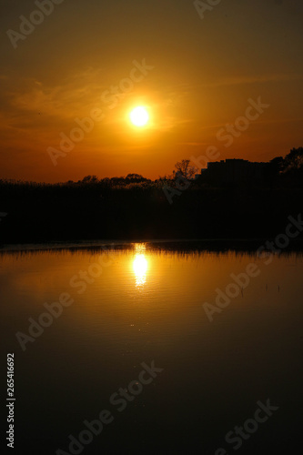 Scenic calm orange sunset over the lake