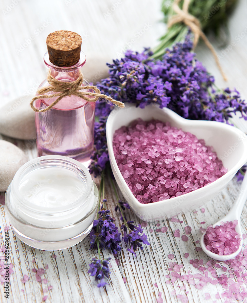 Heart-shaped bowl with sea salt, oil and fresh lavender flowers Heart-shaped bowl with sea salt, oil and fresh lavender flowers