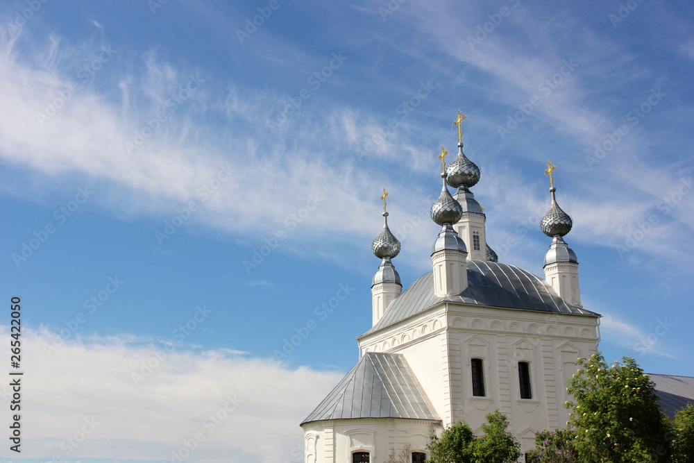 Church with five domes with Golden crosses and blue sky with clouds