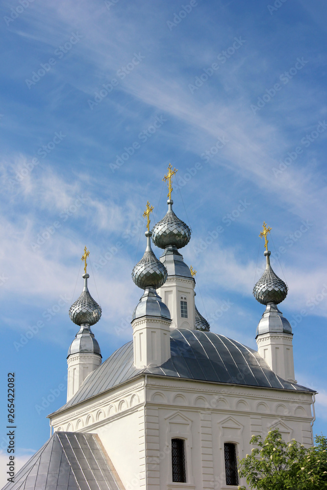 white Church with gold crosses on the towers and blue sky with clouds. white Church with gold crosses on the towers and blue sky with clouds.